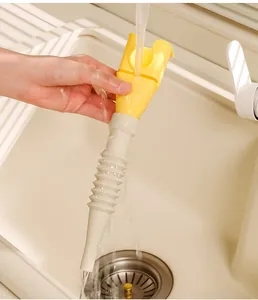 Close-up of a detachable plastic kitchen funnel being rinsed under a faucet in a sink