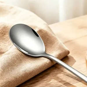 316 stainless steel dinner spoon with mirror polished finish on wooden table