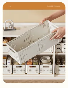 Detailed view of cream retractable storage basket being held to show expandable plastic design