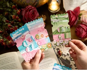 Close-up of oil painting style magnetic bookmarks held in hands for journaling