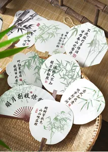 Close-up of traditional Chinese style decorative paper cards with bamboo and calligraphy