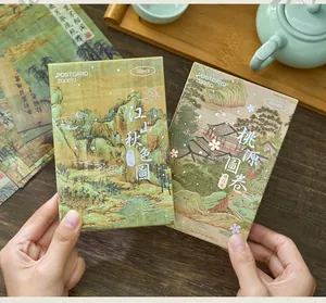 Detailed view of traditional Chinese landscape painting postcards in elegant gift boxes