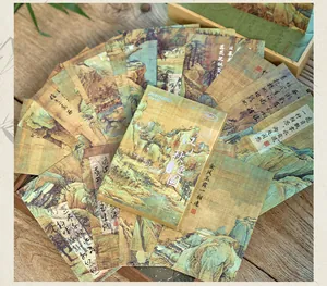 Macro detail view of ancient Chinese style landscape postcards with silver stamping accents (87 chars)