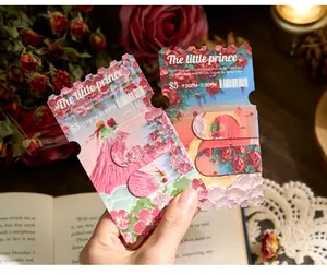 Close-up view of two vintage ticket-shaped magnetic bookmarks with oil painting rose textures.