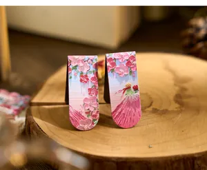 Close-up of artistic oil pastel style magnetic bookmarks with pink floral design