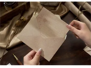 Detailed macro shot of vintage kraft paper envelope and floral printed letter writing set