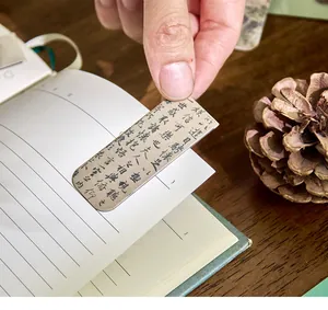 Detailed macro view of a magnetic bookmark featuring elegant vintage Chinese calligraphy.