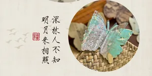 Detailansicht einer Postkarte in Schmetterlingsform im chinesischen Stil mit Kalligrafie.