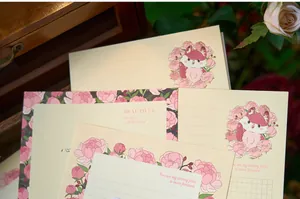Detail view of floral letter paper set with gold foil text and fox illustration