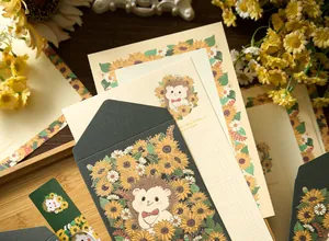 Close-up of sunflower themed stationery set with gold-stamped envelopes and writing paper.