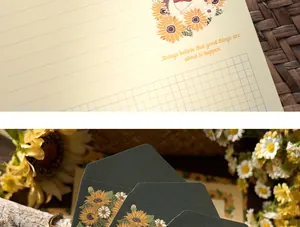 Close-up of elegant floral writing paper and gold foil sunflower envelopes