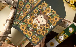 Close-up of artistic stationery set featuring cute hedgehog and sunflower patterns