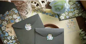 Vintage stationery set detail featuring gold foil floral envelopes and cute hamster stickers.