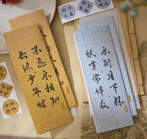 Close-up of Chinese calligraphy letterheads with gold-flecked texture in vintage scene