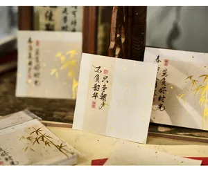 Close-up view of vintage Chinese style memo pad paper with gold foil bamboo details