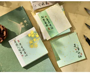 Vintage style sticky notes with Chinese calligraphy and gold foil details close-up