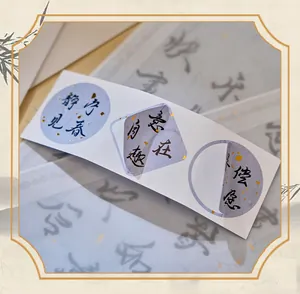 Detailed view of Chinese calligraphy stickers with gold foil accents for art journaling