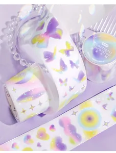 Primo piano di nastri washi decorativi con motivi olografici di farfalle e stelle pastello