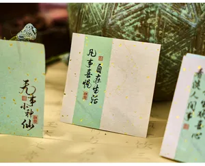 Close-up of traditional Chinese style memo paper with gold foil and calligraphy