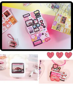Detailed macro view of retro pop-up window and heart stickers on earphone case and keychain.