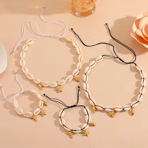 Natural white cowrie shell jewelry set with golden starfish and dolphin charms