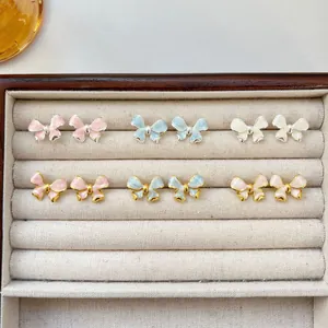 Beautiful collection of colorful French vintage bow stud earrings in a jewelry case