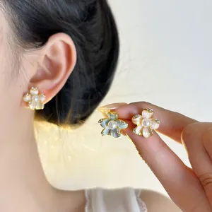 Elegant floral petal stud earrings with pink and blue enamel, pearls, and silver needles