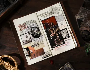 Detailed view of vintage gold foil botanical stickers arranged in a leather journal