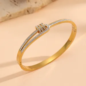 Close-up detail of 18k gold plated titanium steel rhinestone cuff bangle bracelet