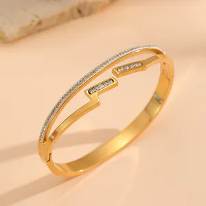 Detailed close-up of 18k gold plated titanium steel bangle with inlaid crystals