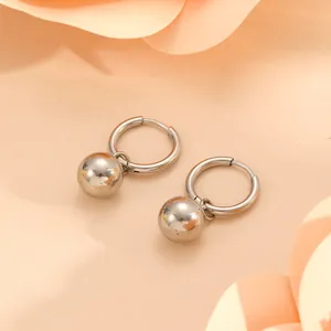 Close-up detail of silver stainless steel ball hoop earrings with high-polish finish