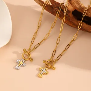 Detail view of vintage bicolor cross pendants on paperclip chains with OT buckles