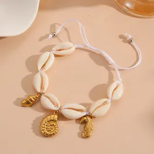 Close-up detail of natural shell bracelet with golden seahorse and shell charms