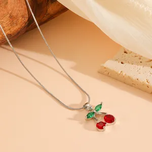 Exquisite close-up of a sweet red cherry crystal pendant necklace with green leaves