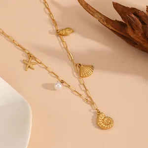 Detailed shot of gold stainless steel ocean beach theme necklace with starfish and pearl charms.