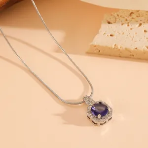 Detail view of an elegant hexagonal pendant featuring a large purple crystal stone