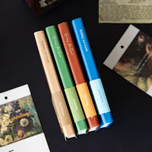 Minimalist hardcover notebooks from the Holiday Art Guide series in various aesthetic colors.