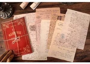 Close-up of vintage medieval-style decorative scrapbook papers and red mini book