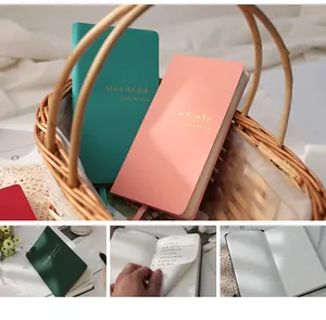 Detail view of hardcover leather planners in various colors with gold foil embossing.