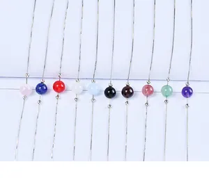 Detailed view of various natural gemstone beads including strawberry quartz and amethyst