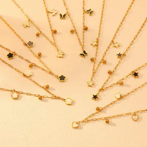Detailed view of gold steel necklaces with butterfly star and flower charms