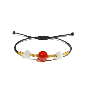 Handmade woven black string bracelet with red agate and white beads centerpiece