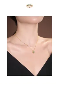 Detail shot of a square Hetian green jade pendant on a gold S925 silver chain necklace.