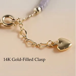 Elegant lepidolite beaded bracelet featuring a 14k gold-filled heart charm and extension chain.