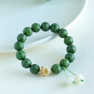 Handcrafted green Bodhi seed mantra bracelet featuring a cute cream cat paw charm accessory.