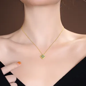 Elegant Hetian green jade square pendant on a gold S925 silver chain worn by a model