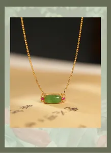 Close-up of elegant S925 gold-plated necklace with green nephrite jade pendant