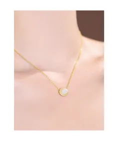 Detail view of elegant s925 sterling silver gold-plated necklace with white jade pendant