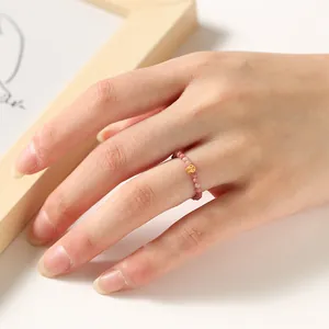 Close-up of an ultra-thin 2mm natural tourmaline beaded ring on a hand.