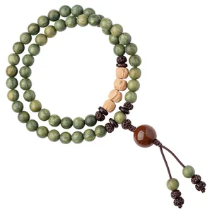 Handcrafted double-strand green sandalwood prayer beads bracelet with natural seed accents